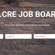 the adventures in cre job board with search box, wood desktop background, and title