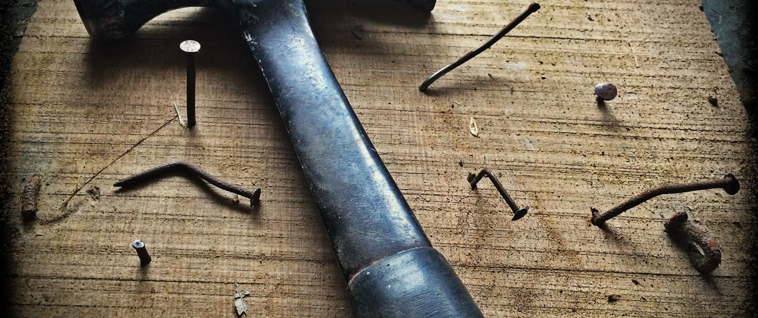 wooden board with multple nails